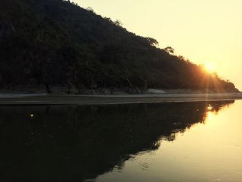 Scenic view of lake against sky at sunset