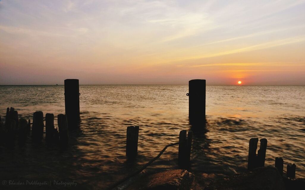 sea, sunset, horizon over water, water, tranquil scene, scenics, tranquility, beauty in nature, sky, idyllic, orange color, nature, pier, sun, wooden post, wood - material, beach, silhouette, reflection, outdoors