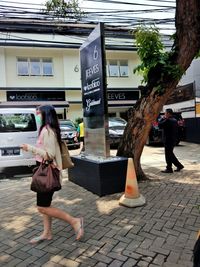 Full length of woman walking on street