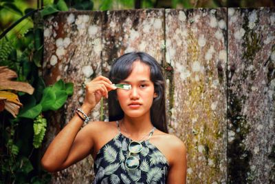 Portrait of woman against plants