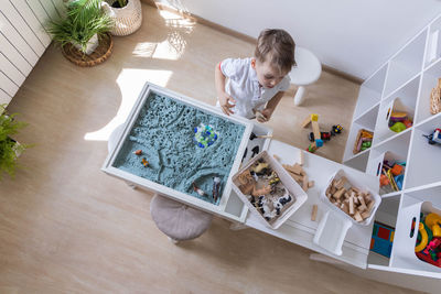 High angle view of girl drawing on table