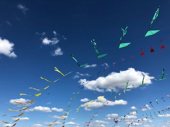 Low angle view of flags against sky