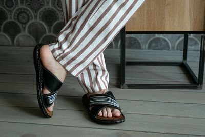 Low section of woman sitting on wooden floor