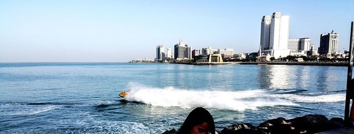 Panoramic view of sea and buildings against clear sky