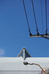 Low angle view of cables against clear blue sky