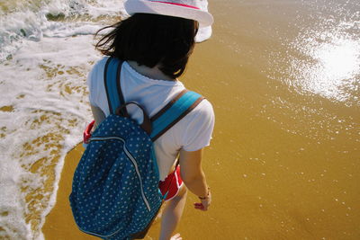 High angle view of woman walking on shore at beach