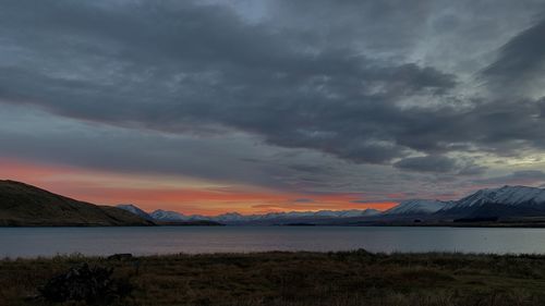 Scenic view of dramatic sky over mountains during sunset