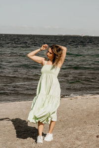 Full length of woman standing at beach