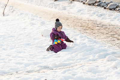 Full length of woman on snow covered land