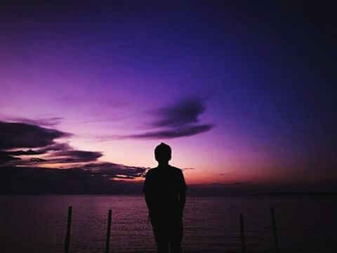 silhouette, sky, water, sea, standing, sunset, one person, rear view, scenics - nature, beauty in nature, nature, beach, night, cloud - sky, horizon, tranquility, horizon over water, tranquil scene, outdoors, purple, contemplation, looking at view