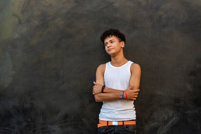 Portrait of smiling boy standing against curtain