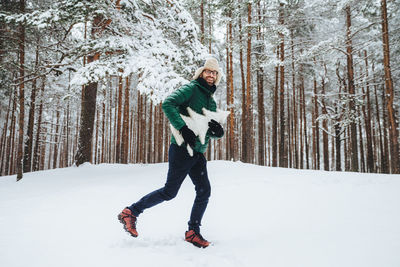 Full length of person standing on snow covered land