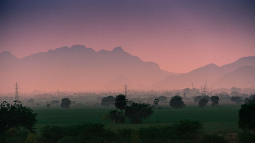 Scenic view of field against sky during sunset