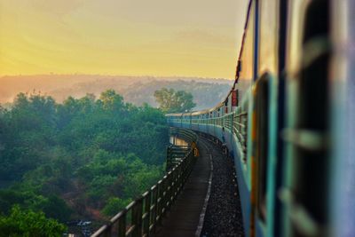 Train on bridge against sky
