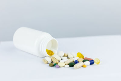 Close-up of bottles on table against white background