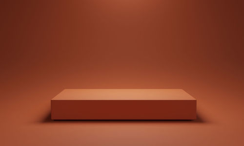 Close-up of paper box against orange background