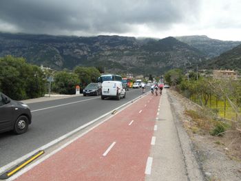 Vehicles on road against mountain range