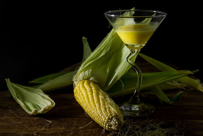 Close-up of drink on table against black background