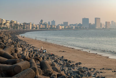 Panoramic view of sea and buildings against sky