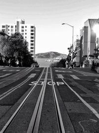 Road by city against sky