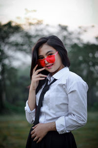 Portrait of young woman wearing shirt and tie