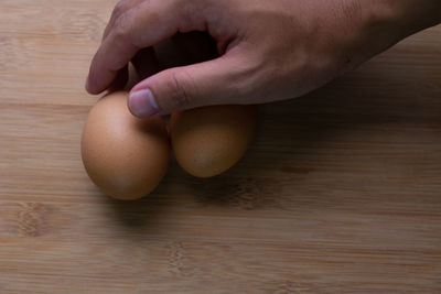 Close-up of hand holding ice cream on table