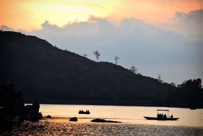 Silhouette boats on sea against sky during sunset