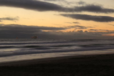View of calm sea against cloudy sky