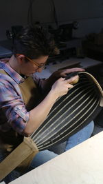 High angle view of boy sitting on chair at home