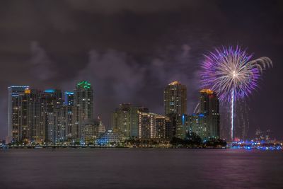 Firework display over city at night