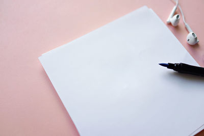 High angle view of pen and paper on table