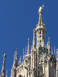 Low angle view of built structure against clear blue sky