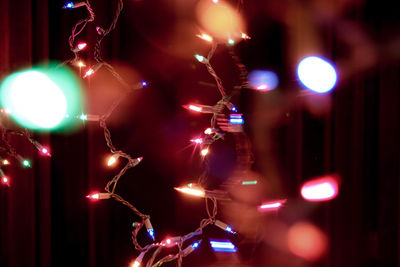 Illuminated christmas lights hanging at night