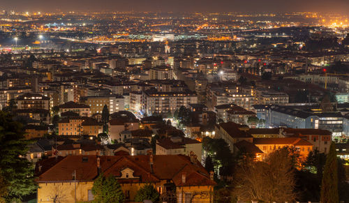 High angle view of illuminated buildings in city