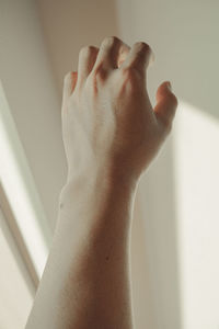 Close-up of man hand on wall