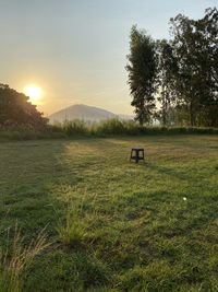 Scenic view of field against sky during sunset