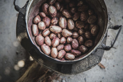 High angle view of jackfruit seeds in container on wood burning stove