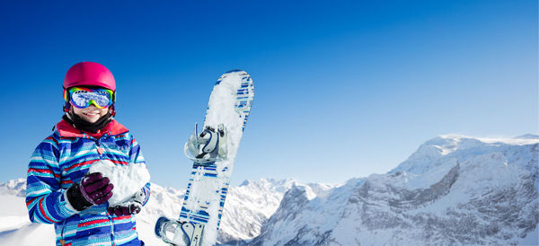 Portrait of woman skiing on snowcapped mountain