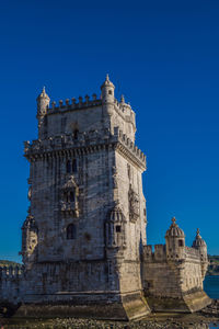 Low angle view of historical building against blue sky