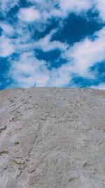 Scenic view of desert against blue sky