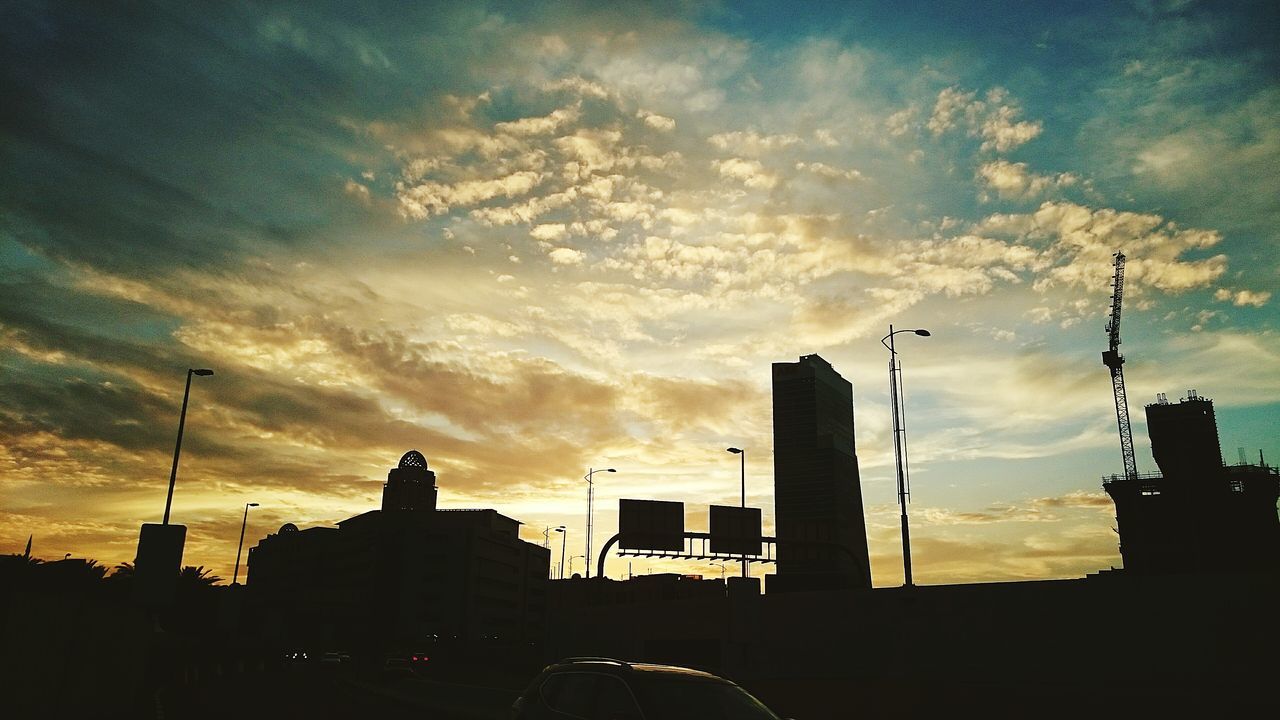 building exterior, silhouette, architecture, built structure, sunset, sky, cloud - sky, city, low angle view, building, dusk, cloudy, cloud, dark, residential building, residential structure, outline, outdoors, dramatic sky, no people