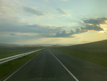 Empty road along countryside landscape