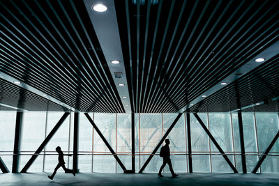 Side view of people walking in modern building