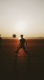 Silhouette of woman at sunset