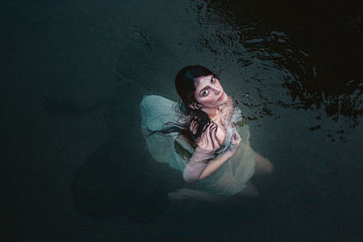 Portrait of young woman in water