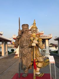 Statue of temple against building