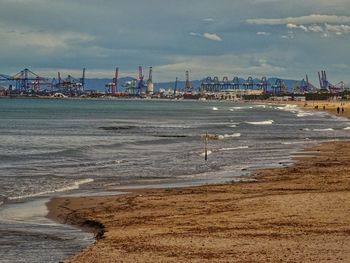 View of beach against cloudy sky