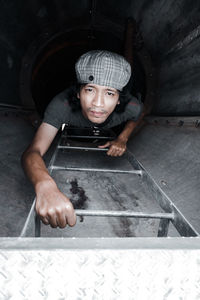 High angle portrait of young man holding camera