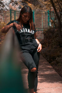 Full length of woman sitting outdoors