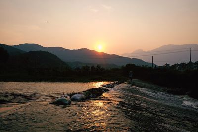 Scenic view of lake against sky during sunset